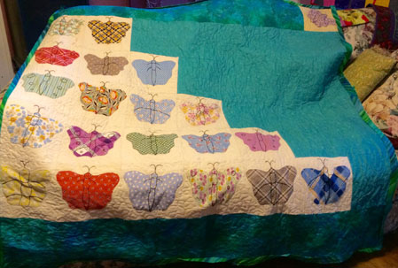Leeanna Walker set her vintage butterfly blocks in this asymmetrical way which features large amounts of "negative space" . Her quilt inspired me to try this technique.